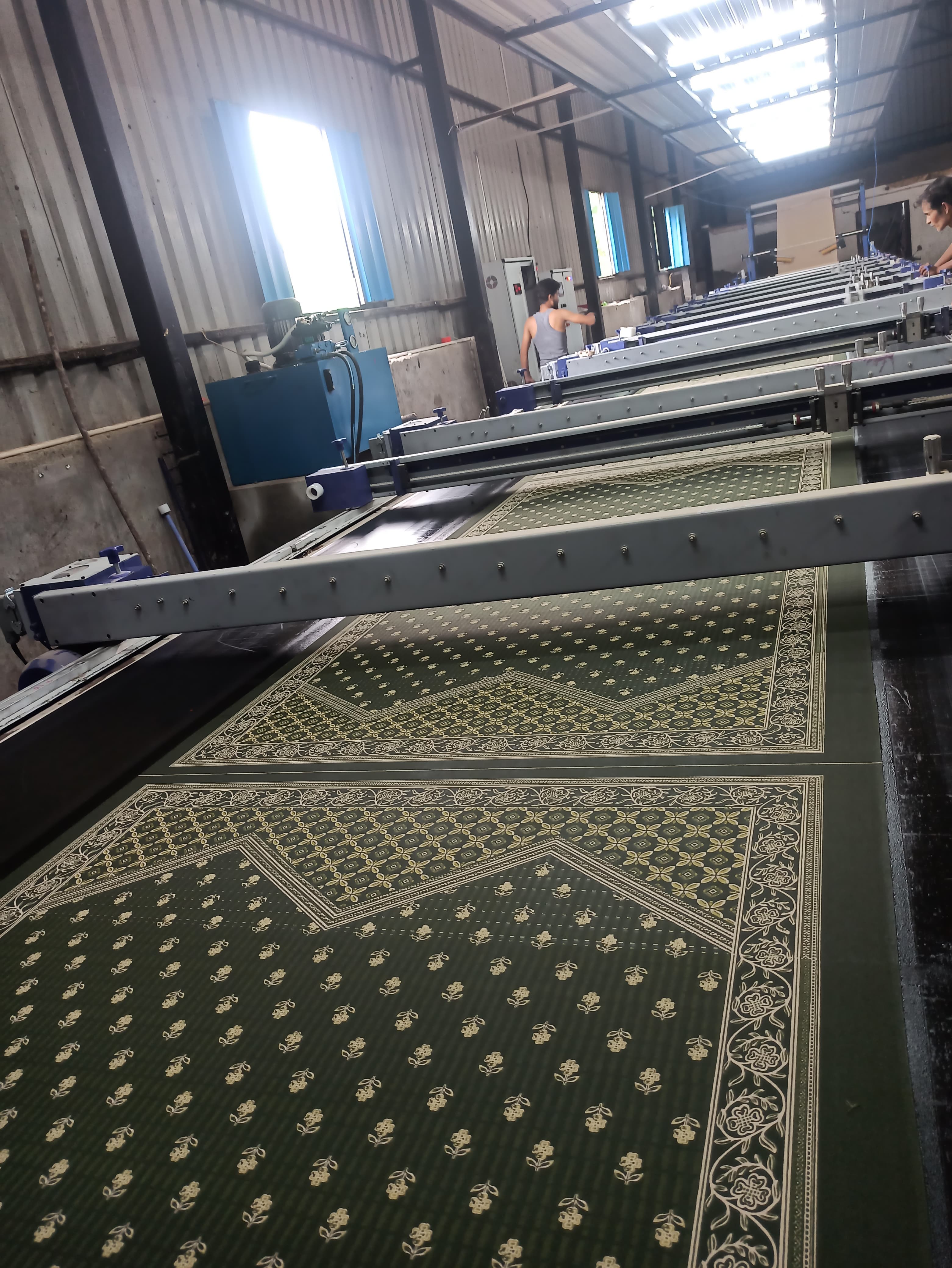 Continuous fabric print run with green Sanganeri pattern